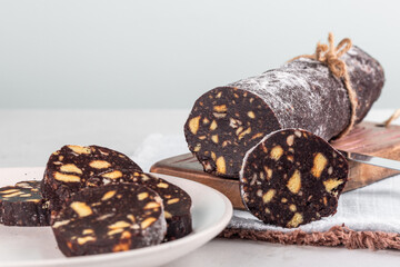 Homemade chocolate salami - dessert made from cocoa, broken biscuits, butter and eggs, with...