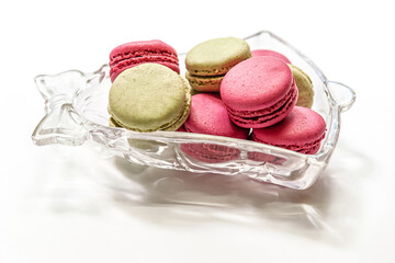 raspberry and pistachio macaroon cakes in a bell shaped glass bowl
