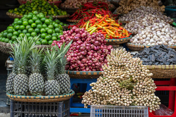 Fresh vegetables and fruits for sale at street food market in the old town of Hanoi, Vietnam