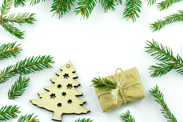 Christmas tree and present. New year background. Green branches on white minimal backdrop. Space for your text