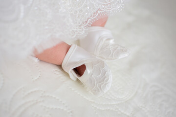 Fototapeta na wymiar white lace booties for a newborn girl