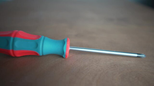 Detail of a screwdriver laid on the wooden table