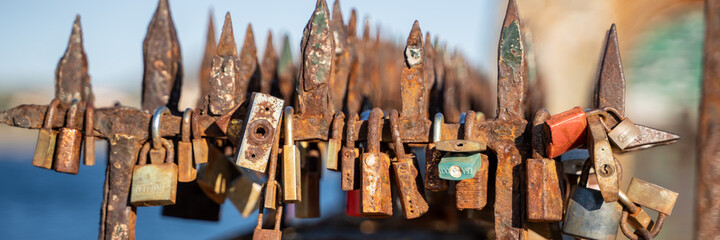 Rusty locks on a seafront railing