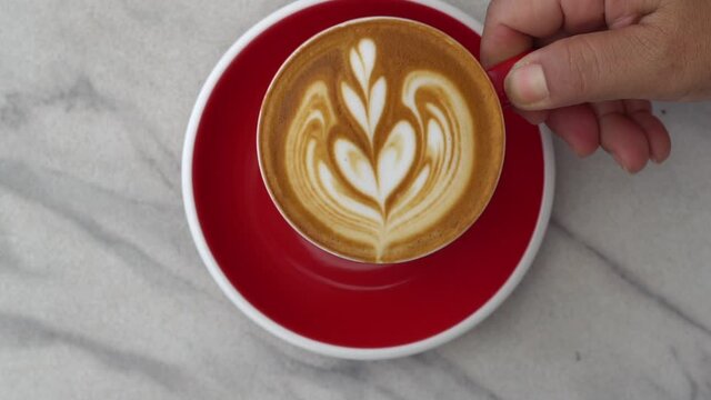 Hot coffee with smoke on mable table, The best material for processing fresh coffee. Coffee cup on interior cafe background, free space for text. Industrial food and drink background concept.