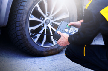 Close-up of manometer and man hands checking tire pressure with gauge. High quality photo