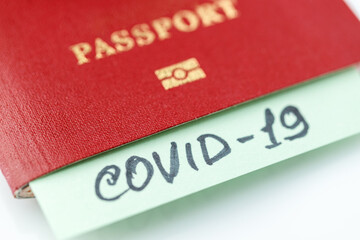 Coronavirus and travel concept. Note COVID-19 coronavirus and passport. Travel restrictions and quarantine of tourists infected with сoronavirus.