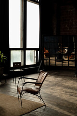 leather upholstered chair stands in empty room bathed in sunlight