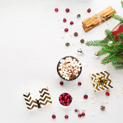 Christmas decoration, cup of coffee, homemade sweet gingerbread cookies, pine cones and branches on white wooden background.