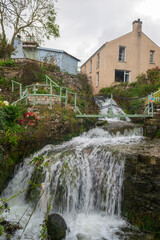 Fototapeta na wymiar Waterfall next to a house