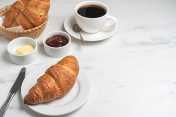 Breakfast with croissant and coffee