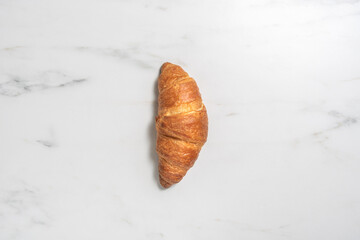Fresh croissant on marble