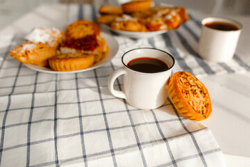 Appetizing rye flour pastries on a table on a linen towel with natural light