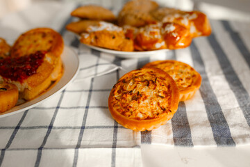 Appetizing rye flour pastries on a table on a linen towel with natural light