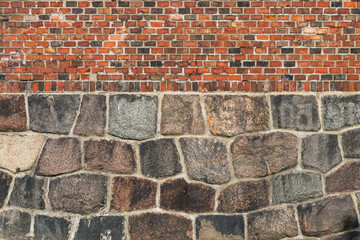Texture of brickwork on a stone foundation. Wall of an old building.