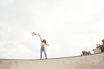 Young woman in freedom waving her shirt. Copy space. Freedom concept.