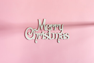 Wish MERRY CHRISTMAS on pink background.