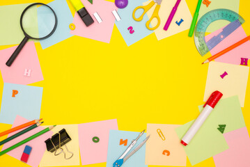 The concept of school, student, training, office. Frame of empty note papers and stationery. Yellow background, free space for text. Top view.