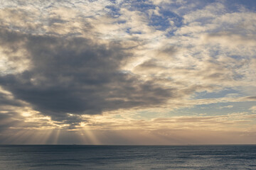 Stormy skies over the sea with varying colours and cloud formations
