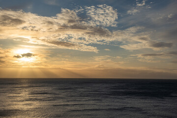 Stormy skies over the sea with varying colours and cloud formations