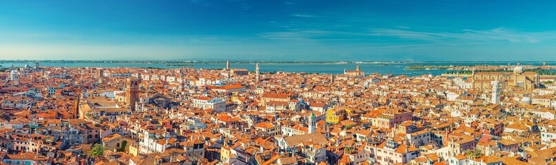 Fototapeta premium Aerial panoramic view of Venice city old historical city centre, buildings with red tiled roofs, San Giuliano Mestre and blue sky background, Veneto Region, Northern Italy. Amazing Venice cityscape.