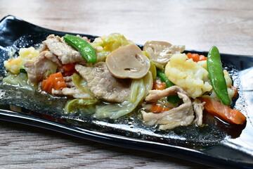 fried mixed vegetable with slice pork with soy sauce on plate