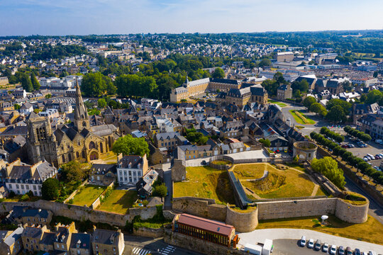 Flight over the city Guingamp and Basilica of Our Lady of Merciful on summer day. France