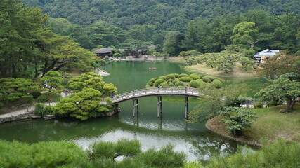 Japanese temple garden with moss, maple trees, gates and bridges