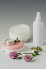 Natural cosmetics for face and body skin care based on clover flowers. Selective focus.
