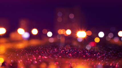 Dark blurred abstract background. Blaze of blurry lights. Reflection of city lights on the asphalt....