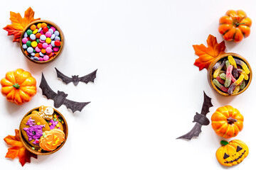Halloween holiday background - gingerbread cookies, pumpkins and candy. Overhead