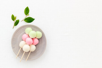 Japanese Dango dessert in pink, white and green colors, copy space