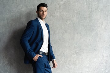 Handsome man wear blue suit isolated on grey background