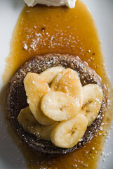 Banana Fosters Dessert. Classic American or French bakeries or pastry shop favorites. Cookies, whipped cream, cakes, chocolate syrup butter, eggs and vanilla beans.