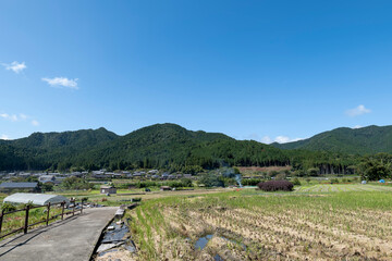 A view of an agricultural village deep in the mountains of Japan, taken on a clear day