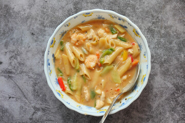 top view of vegetable soup in a bowl on black background 