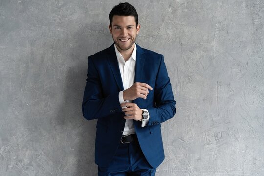 Handsome man wear blue suit isolated on grey background