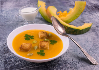 Pumpkin puree soup with cream and garlic croutons.
Close-up.