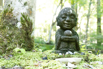 Fototapeta na wymiar A small stone-built Jizo in a Japanese garden