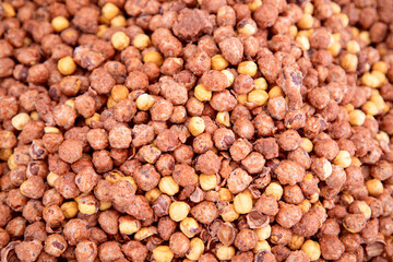 Roasted hazelnuts in sugar glaze. Traditional sweetness at food market (Selective focus)