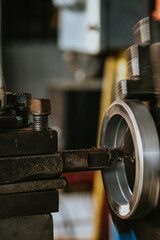 Technicians are setting up a lathe center in an industrial factory.