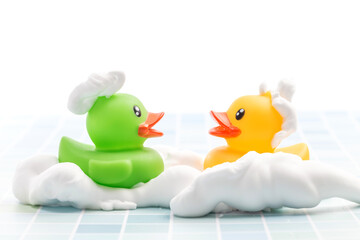 A toy duck covered in foam taking a bath