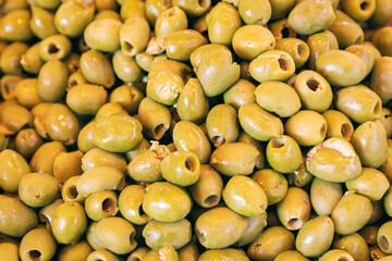 Full frame of green olives. Background with green olives (Selective focus)