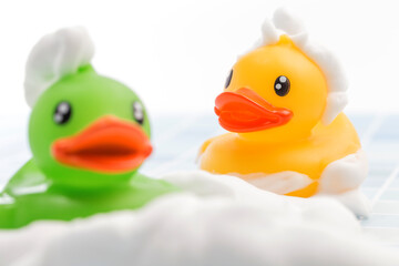 A toy duck covered in foam taking a bath