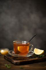 hot black tea with honey and lemon in a glass mug