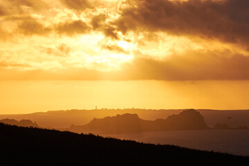 Beautiful sunset at the coast of Brittany, France. Romantic sunset at the beach.