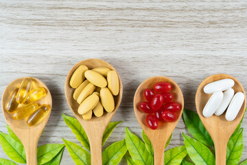 Alternative medicine, pills tablet, capsule and vitamin organic supplements good for health in wood spoon on white background with copy space, medicine and drug concept