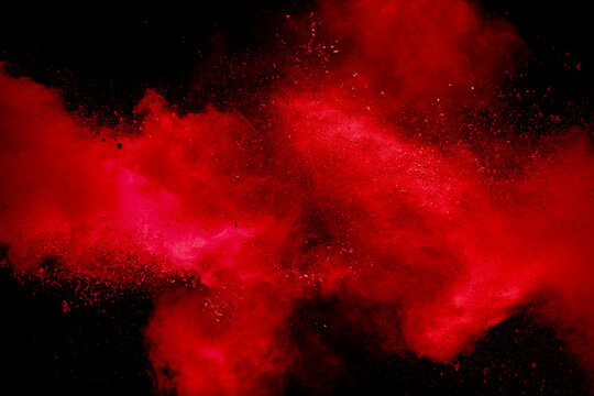 Red powder explosion on black background. Freeze motion of red dust particles splash. © Pattadis