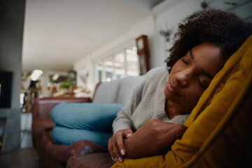 Tired african woman sleeping cozy on comfortable sofa at home