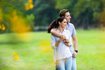 Romantic couple in love concept. Young happy couple enjoying picnic at the park on a holiday.