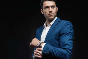 Handsome man wear blue suit isolated on black background